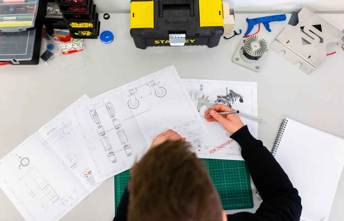 Engineering drawing and part identification documents being checked before a supplier order